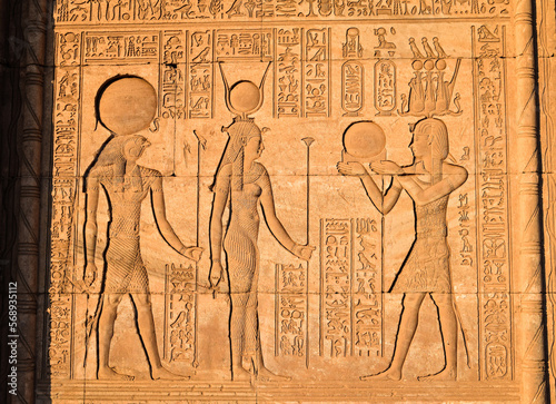 Emperor Trajan handing mirror to Hathor and Khonsu at Dendera Temple iin Egypt. photo