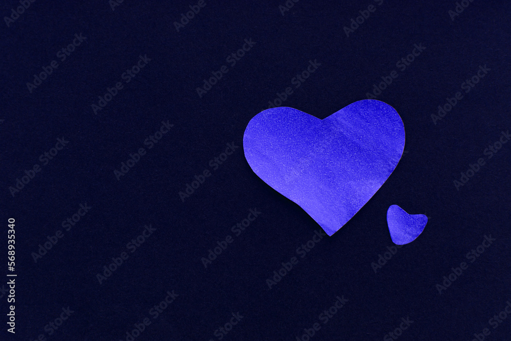 Fototapeta premium Two blue sparkling heart on a dark blue background, made of paper, romantic and festive beautiful symbol, background. Paper textures, valentines day