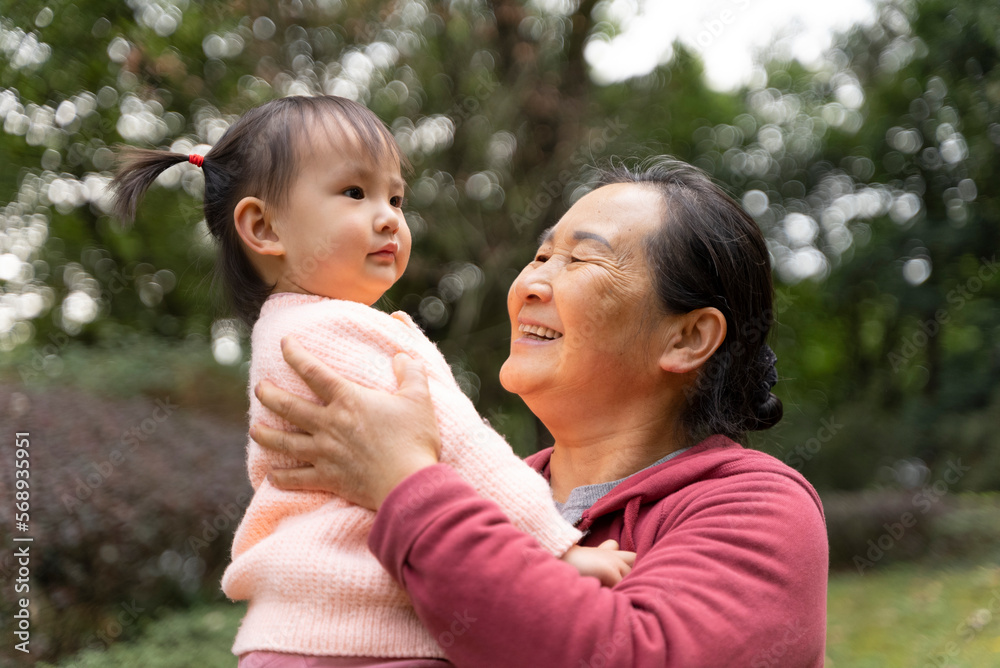 grandmother kiss her granddaughter in the park grandmother kiss her granddaughter in the park