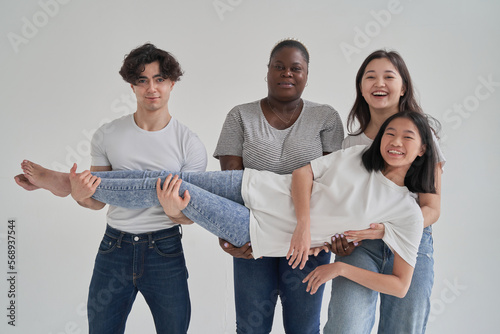 Asian woman in arms of diverse friends