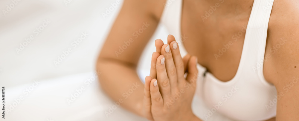 Girl does yoga. Young woman practices asanas on a beige one-ton background. Girl does yoga. Young woman practices asanas on a beige one-ton background.