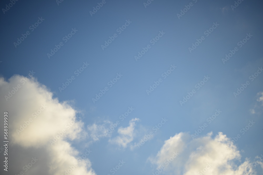 rays of the sun through the cirrus clouds against the blue sky, white rainy clouds blue sky illuminated by the rays of the sun, one small cirrus cloud blurred clouds background rays of the sun through the cirrus clouds against the blue sky, white rainy clouds blue sky illuminated by the rays of the sun, one small cirrus cloud blurred clouds background