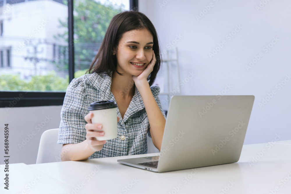 Happy woman working at the office with cups of coffee. businesswoman drinking coffee Happy woman working at the office with cups of coffee. businesswoman drinking coffee
