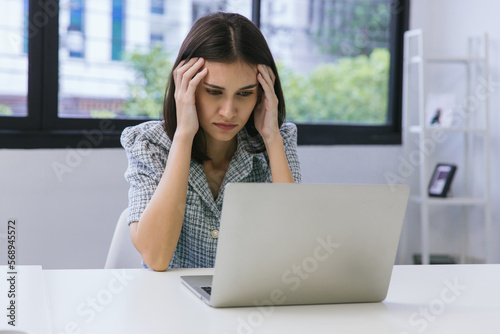 Business woman working on laptop computer in modern home office. Woman Serious working on laptop. Serious mature older adult woman watching on laptop working from home.