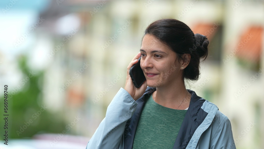 Perosn ending phone call. Woman standing outside in city street turns off conversation Perosn ending phone call. Woman standing outside in city street turns off conversation