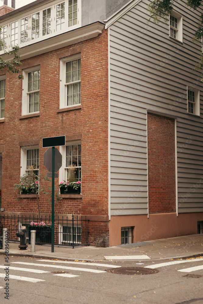 Naklejka premium Crosswalk on road near brick building on street in New York City.