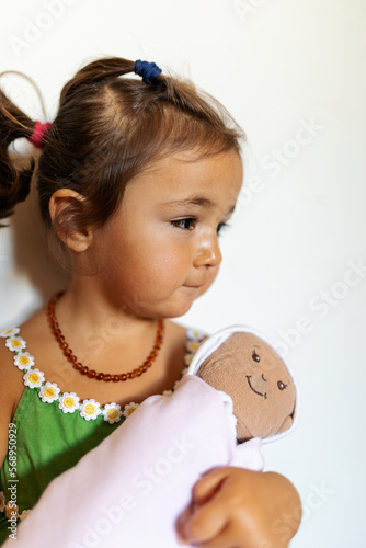 Little girl with stuffed baby photo