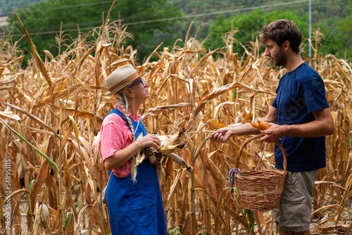 Senior mother and adult son in corn field  photo