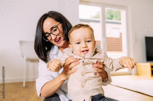 Woman playing with a baby boy  photo