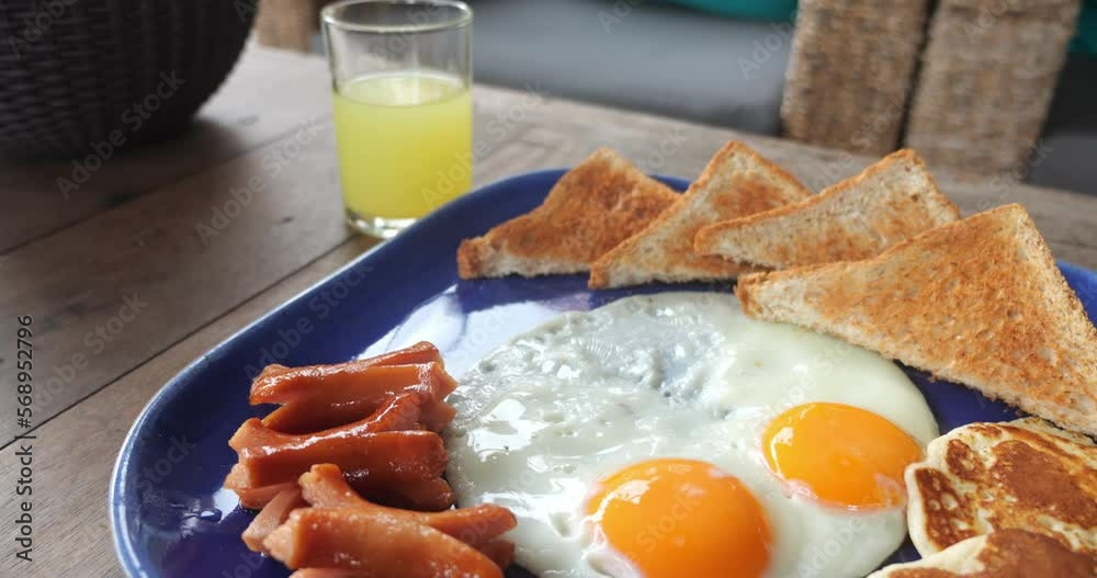 Close up fried unhealthy breakfast On big blue plate, an unhealthy