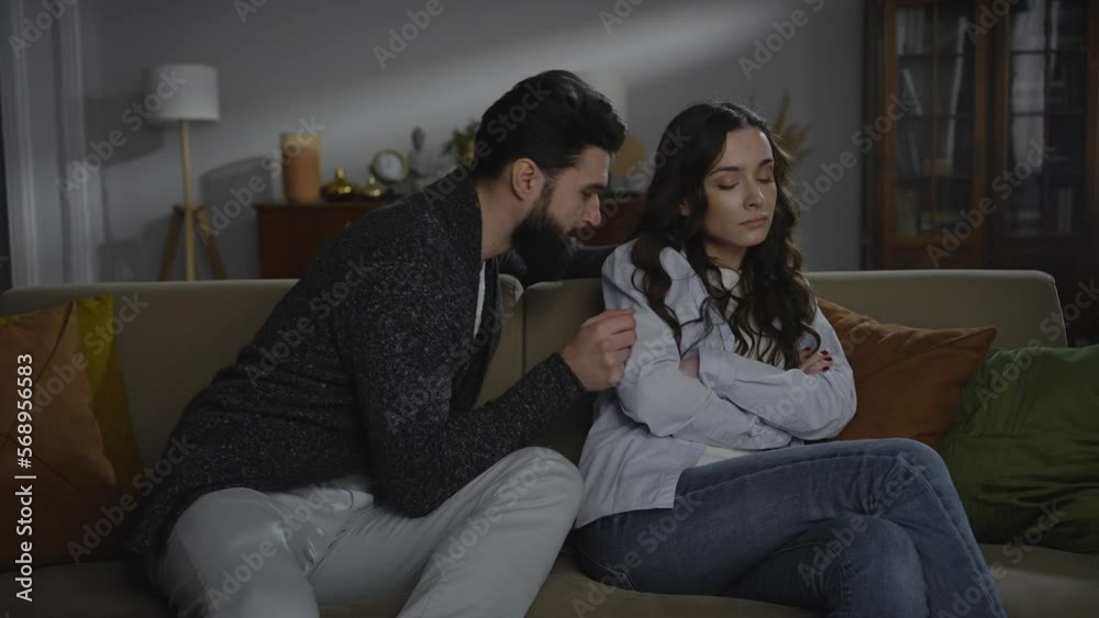 Young woman feel painful after knowing her husband cheating. Young couple reconcile after crisis Young woman feel painful after knowing her husband cheating. Young couple reconcile after crisis