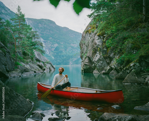 Man canoeing on the lake in Norway photo