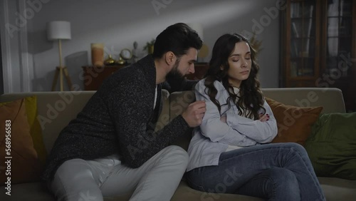 Young woman feel painful after knowing her husband cheating. Young couple reconcile after crisis photo