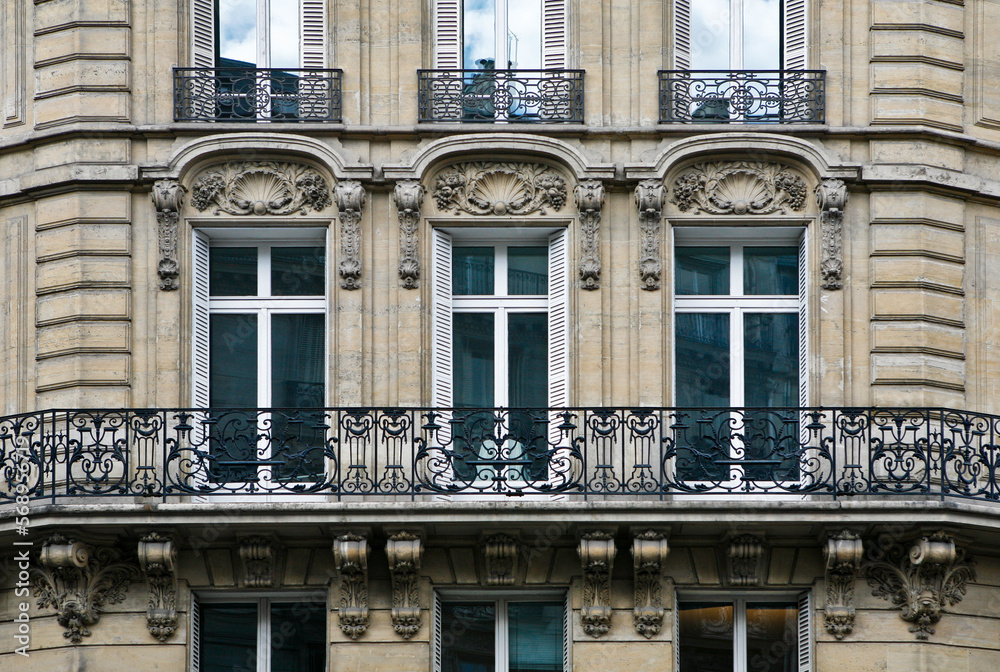 Paris ancient stone building facade with French windows, wrought iron ...
