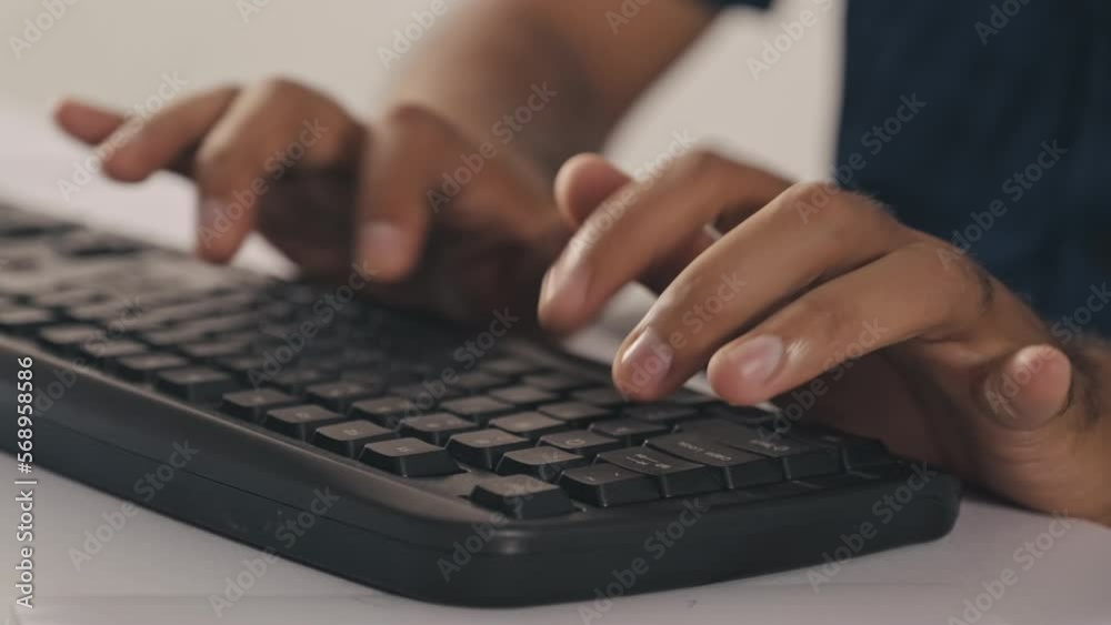 Close up shot of hands of unrecognizable man typing on computer keyboard at office table Close up shot of hands of unrecognizable man typing on computer keyboard at office table
