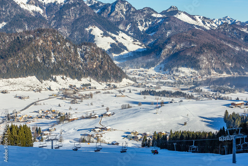 Ski lift against the backdrop of a mountain village on a sunny day