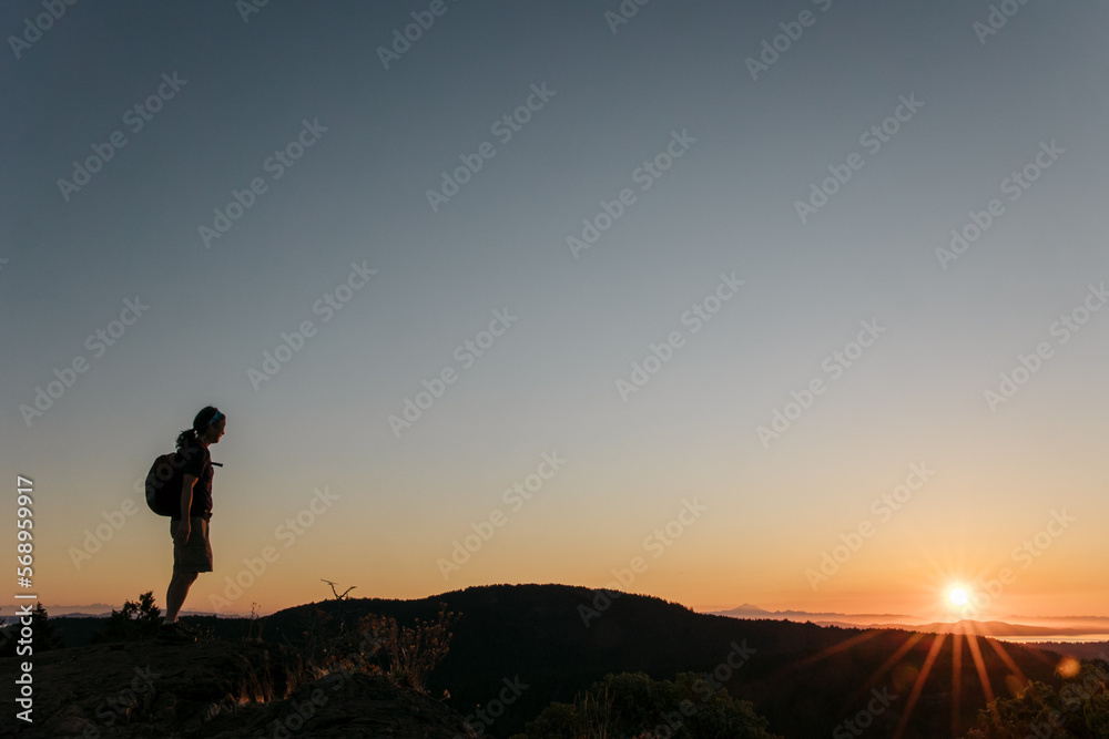 Woman alone on mountain or hill at sunset or sunrise. Woman alone on mountain or hill at sunset or sunrise.