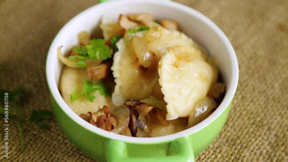 Potato dumplings with onion and mushrooms in a plate. Potato dumplings with onion and mushrooms in a plate.