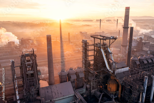 Smelter with blast furnaces from above during autumn foggy morning. Heavy industry plant during sunrise.