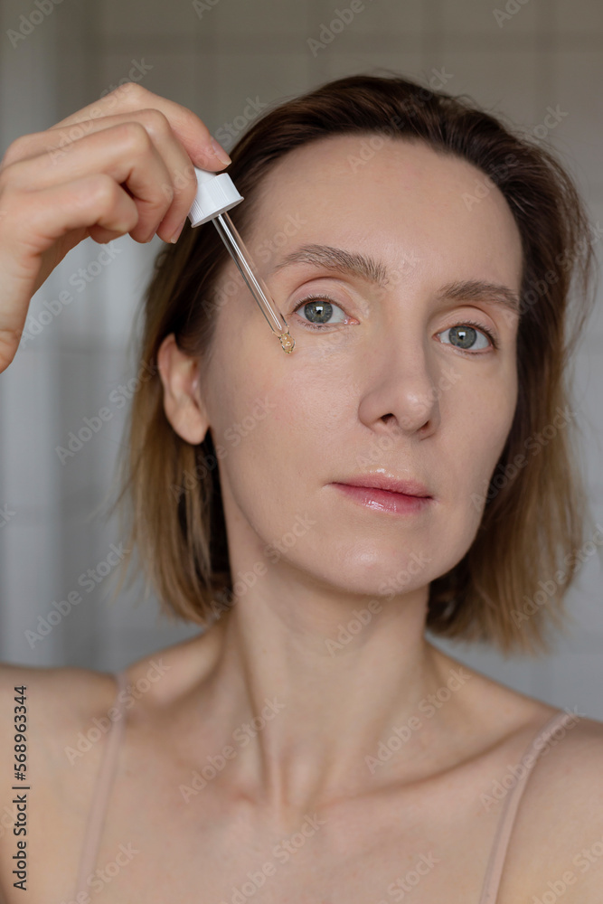 Serum skin care female wellness routine. Portrait of woman.
