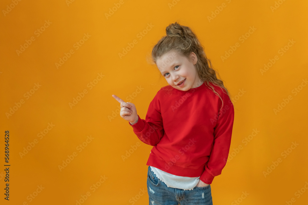 cute joyful baby girl in a red sweater with a red heart in her hands on an isolated yellow background valentine's day concept cute joyful baby girl in a red sweater with a red heart in her hands on an isolated yellow background valentine's day concept