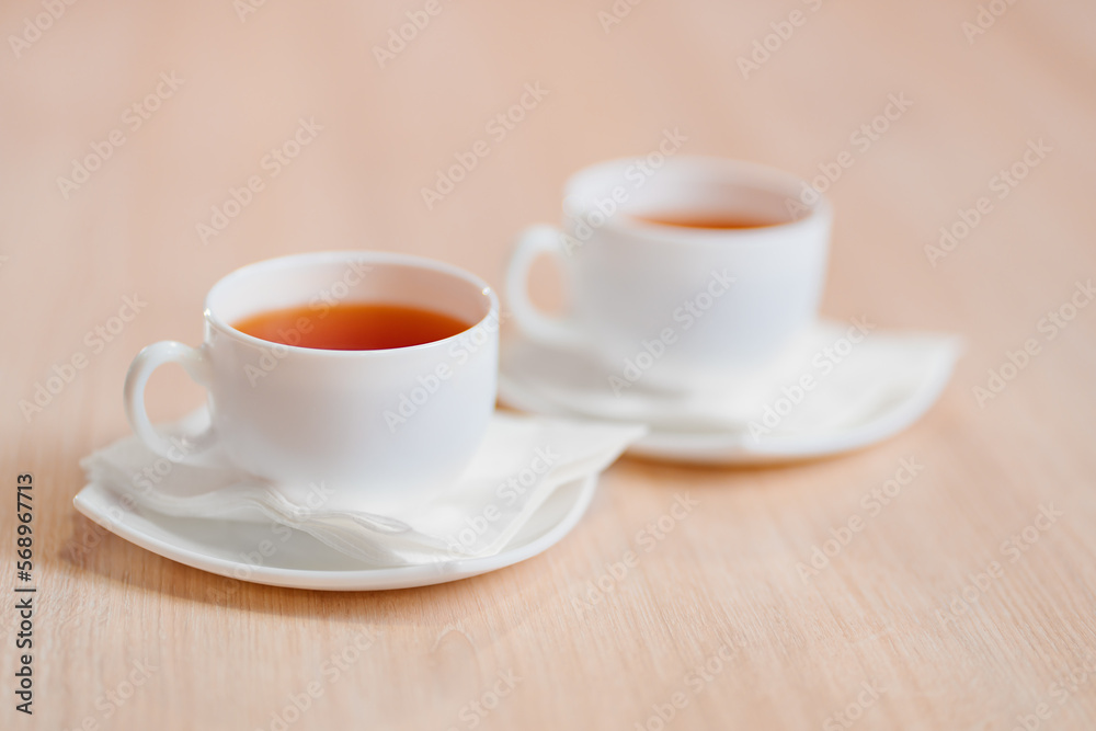 two white cups of tea on the table. the concept of a break at work. two white cups of tea on the table. the concept of a break at work.
