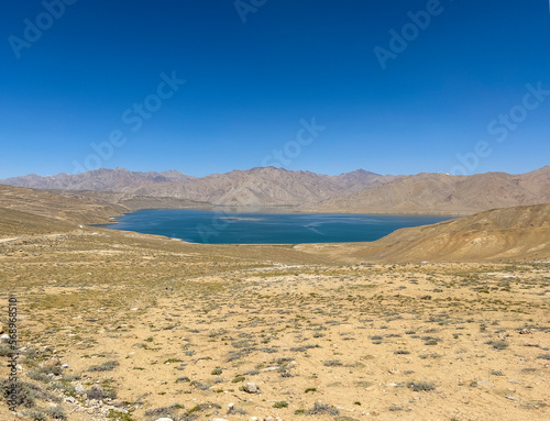 A large lake in the middle of the dry mountain landscape.