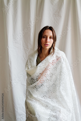 Quiet woman covered by woven cloth. photo