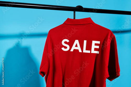 red t-shirt with the word sale in a hanger photo