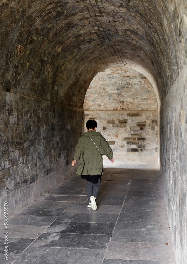 Asian woman, walking in the ancient city wall Asian woman, walking in the ancient city wall