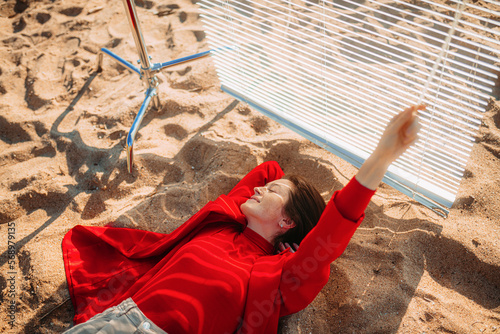 A girl with blinds on the beach protects her skin from the sun's rays
