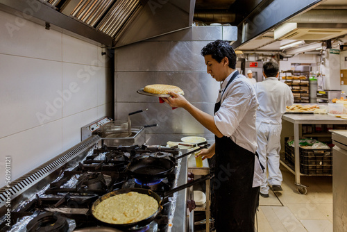 Cook with casserole making spanish omelette