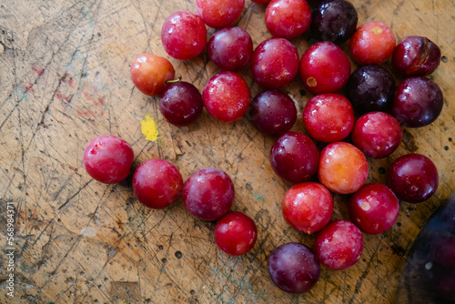 fresh plums on wooden table
 photo