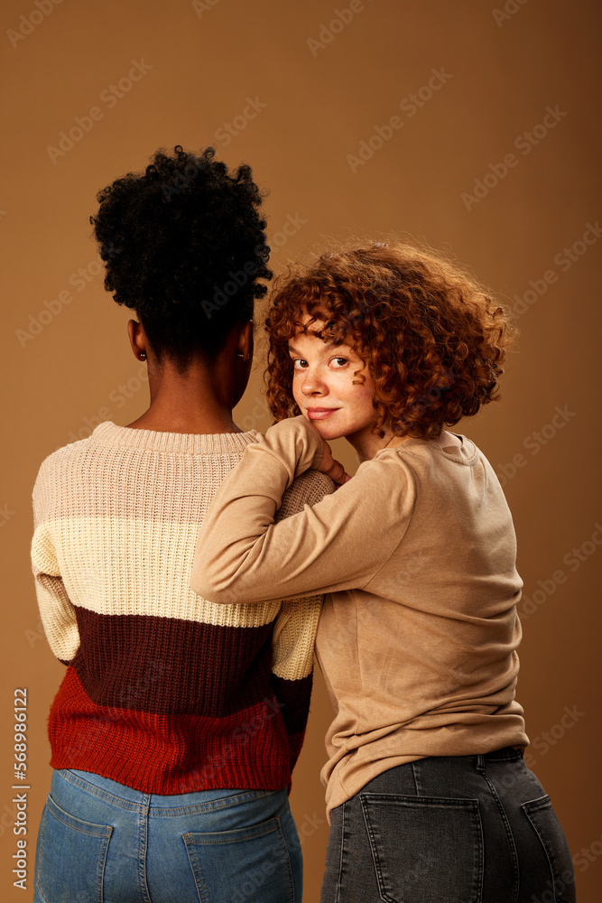 Portrait of multicultural girls posing in studio while looking at the camera. Portrait of multicultural girls posing in studio while looking at the camera.