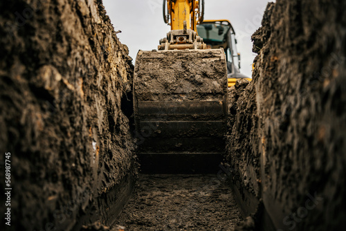 Close up of a bulldozer digging foundation on construction site.