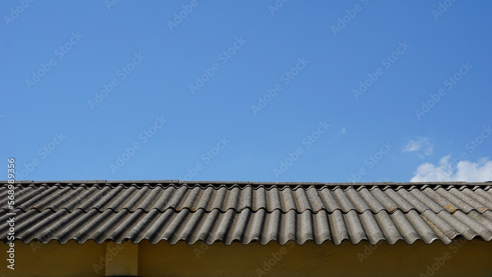 metal roof of industrial warehouse against sky