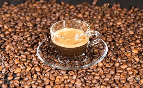 Coffe beans and beautiful cups made of glass.