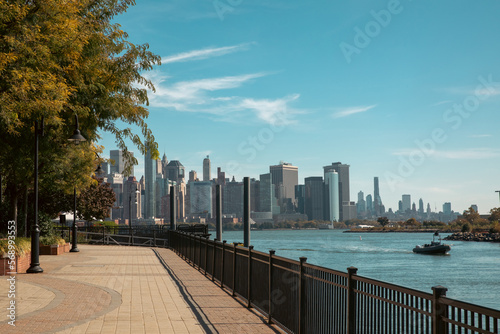 scenic view of Manhattan skyscrapers from embankment of Hudson river in New York City.