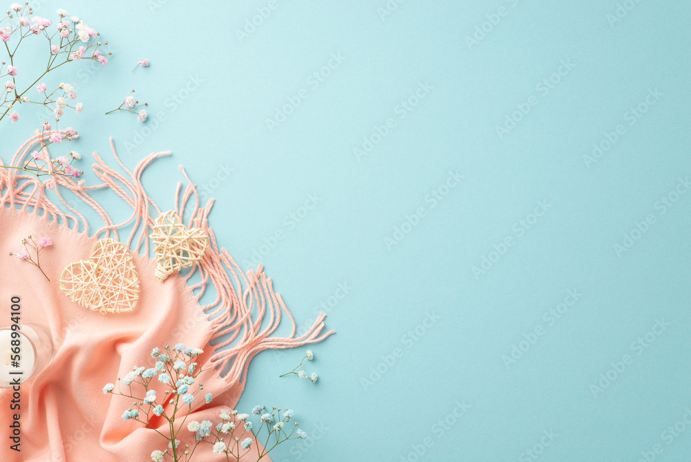 Obraz premium Hello spring concept. Top view photo of two rattan hearts small candle in glass gypsophila flowers and pink scarf on isolated light blue background with copyspace
