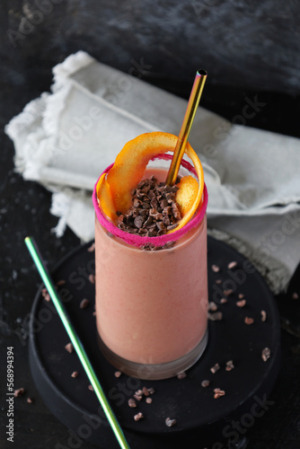 Pink smoothie with orange peel and cacao
