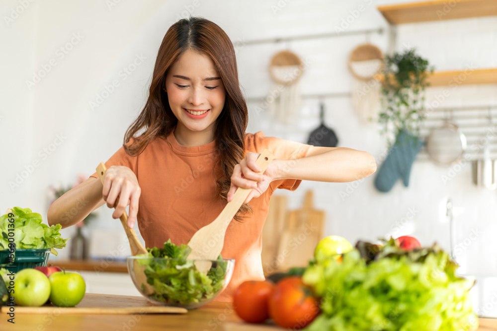 Portrait of beauty body slim healthy asian woman having fun cooking and preparing cooking vegan food healthy eat with fresh vegetable salad in kitchen at home.Diet concept.Fitness and healthy food Portrait of beauty body slim healthy asian woman having fun cooking and preparing cooking vegan food healthy eat with fresh vegetable salad in kitchen at home.Diet concept.Fitness and healthy food