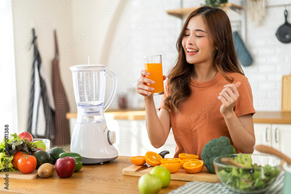 Portrait of beauty body slim healthy asian woman drinking glass of juice and orange.young girl preparing cooking healthy drink with fresh orange juice in kitchen at home.Diet concept.healthy drink Portrait of beauty body slim healthy asian woman drinking glass of juice and orange.young girl preparing cooking healthy drink with fresh orange juice in kitchen at home.Diet concept.healthy drink