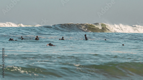Fényképezés group of surfers in the middle of the sea waiting to catch a perfect winter big