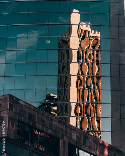 Building with distorted reflection on another building