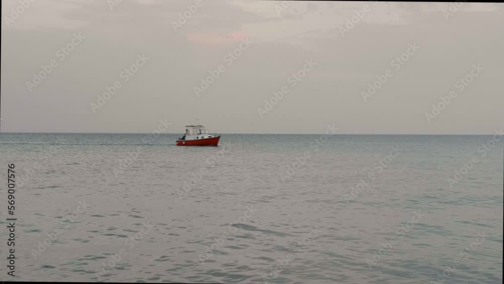 Fisherman on a small boat at sunset Fisherman on a small boat at sunset