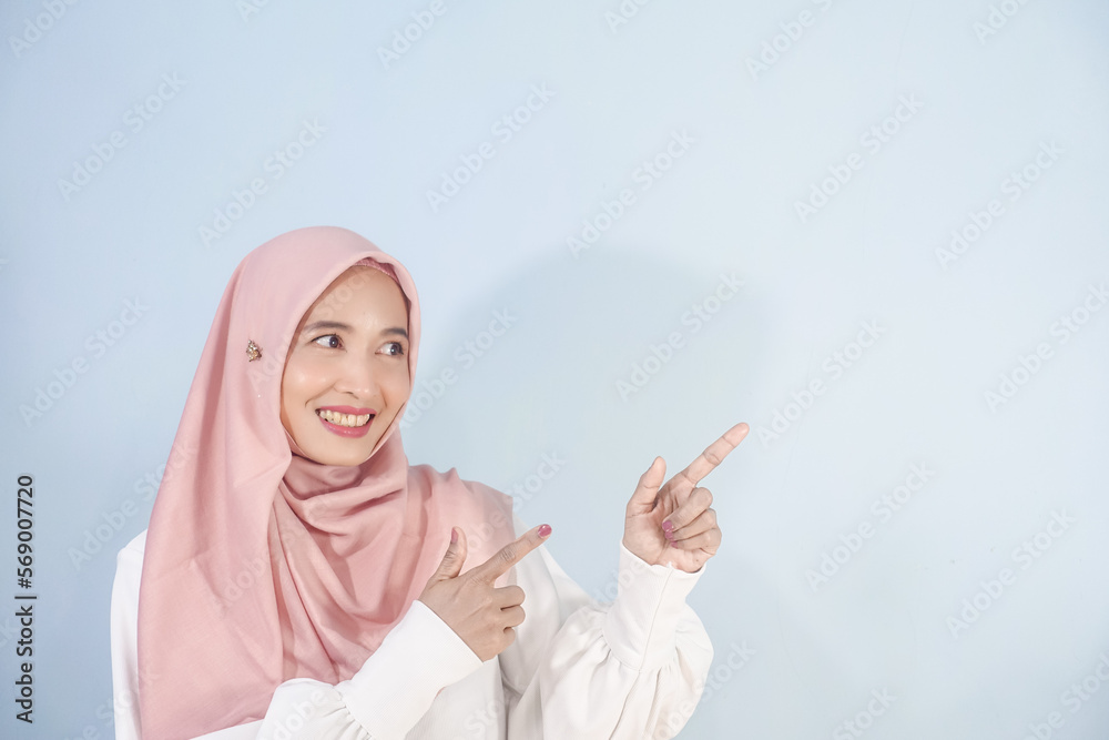 Hijab woman pointing right side Hijab woman pointing right side