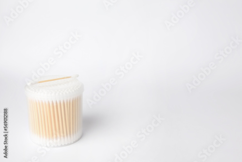 New cotton buds in container on white background. Space for text
