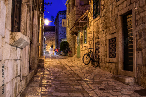 bike in a cobblestone alley at night in Hvar, Croatia