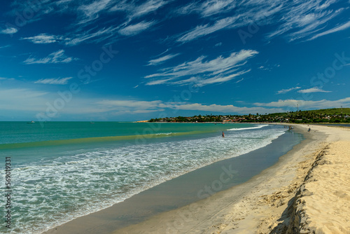 Jericoacoara beach, State of Ceara, Brazil on January 27, 2023. View of the beach with greenish sea and beautiful cirrus clouds formation with blue sky.