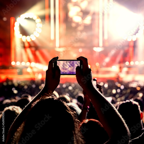 The crowd on a fan zone with the smartphone to record or take pictures during the live concert.